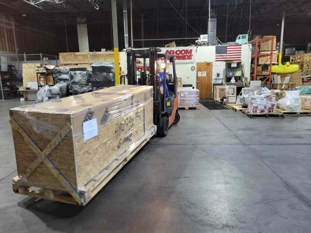 Forklift operator loading oversize crate for final delivery at Tampa dock